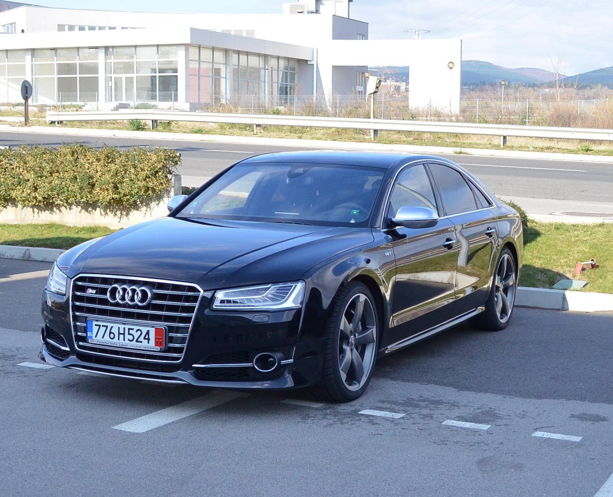 Front-side view showing LED headlights and alloy wheels on a luxury sedan
