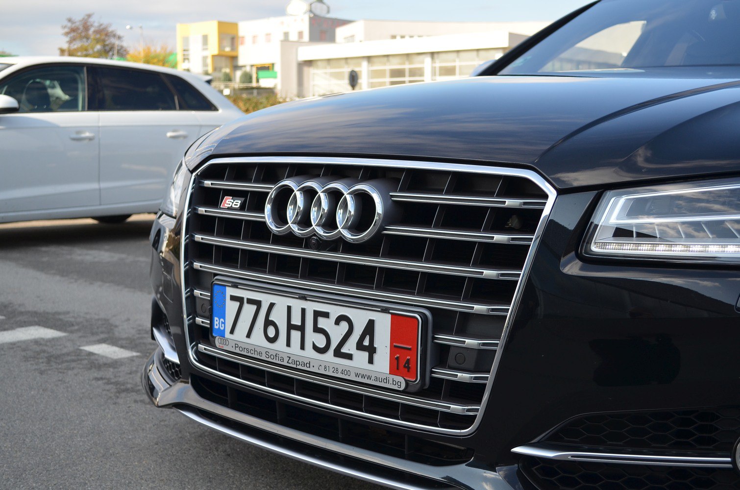 Close-up of Audi's chrome front grille with S8 badge and LED headlights