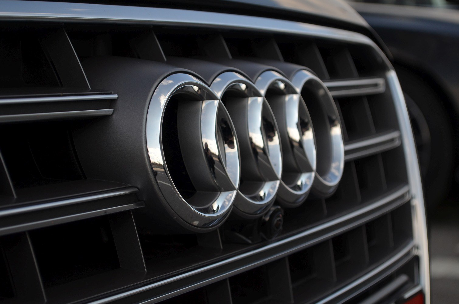Close-up of iconic Audi rings emblem and front grille