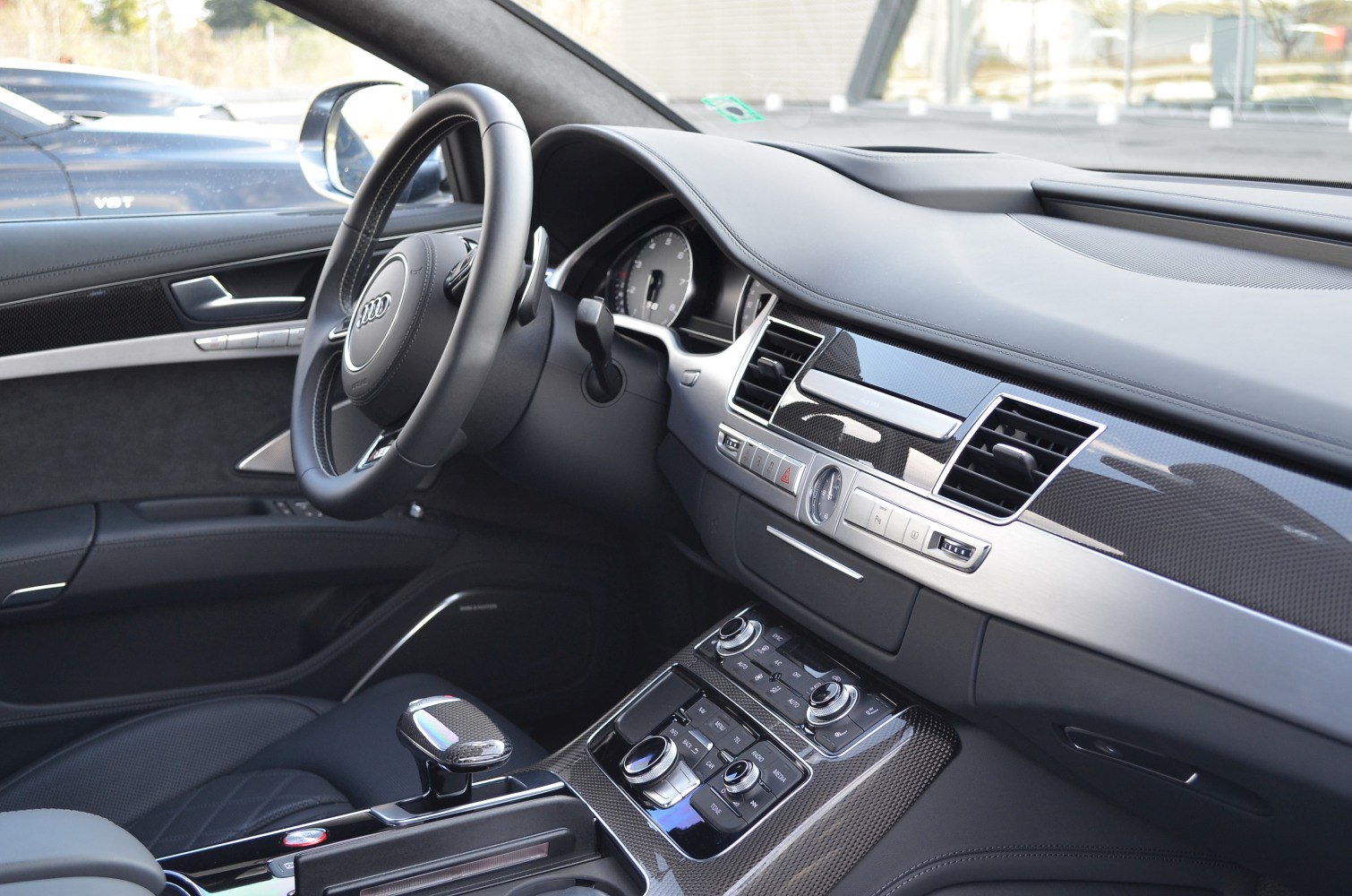 Luxury interior dashboard and center console with carbon fiber trim and advanced controls