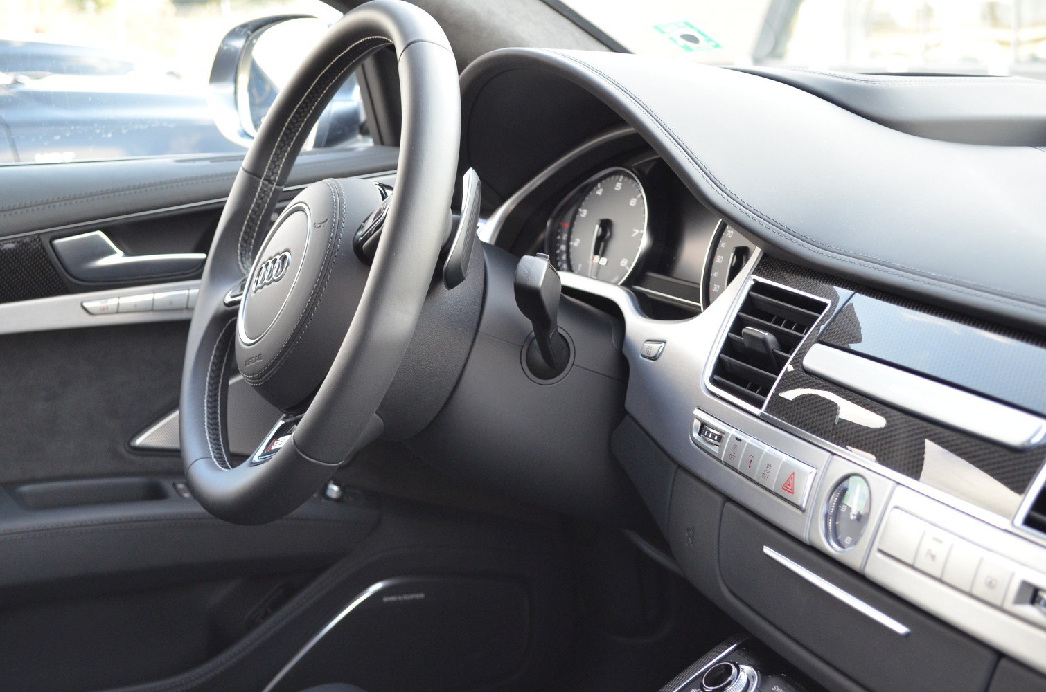 Luxury car interior with steering wheel and dashboard details