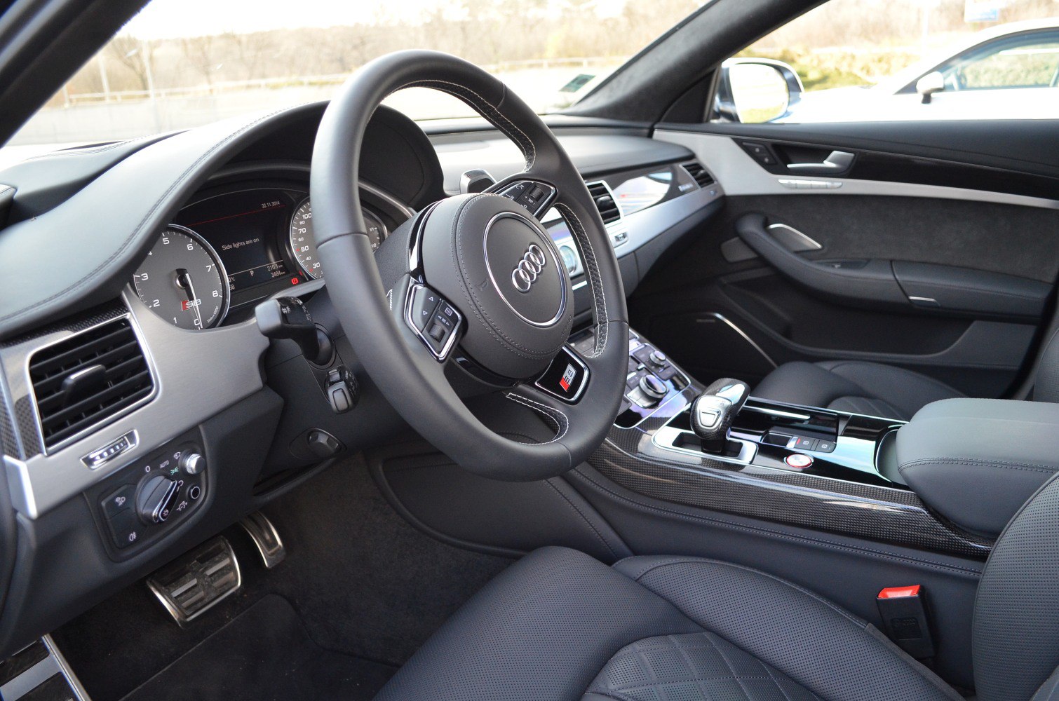 Luxurious steering wheel, dashboard, and center console with carbon fiber trim