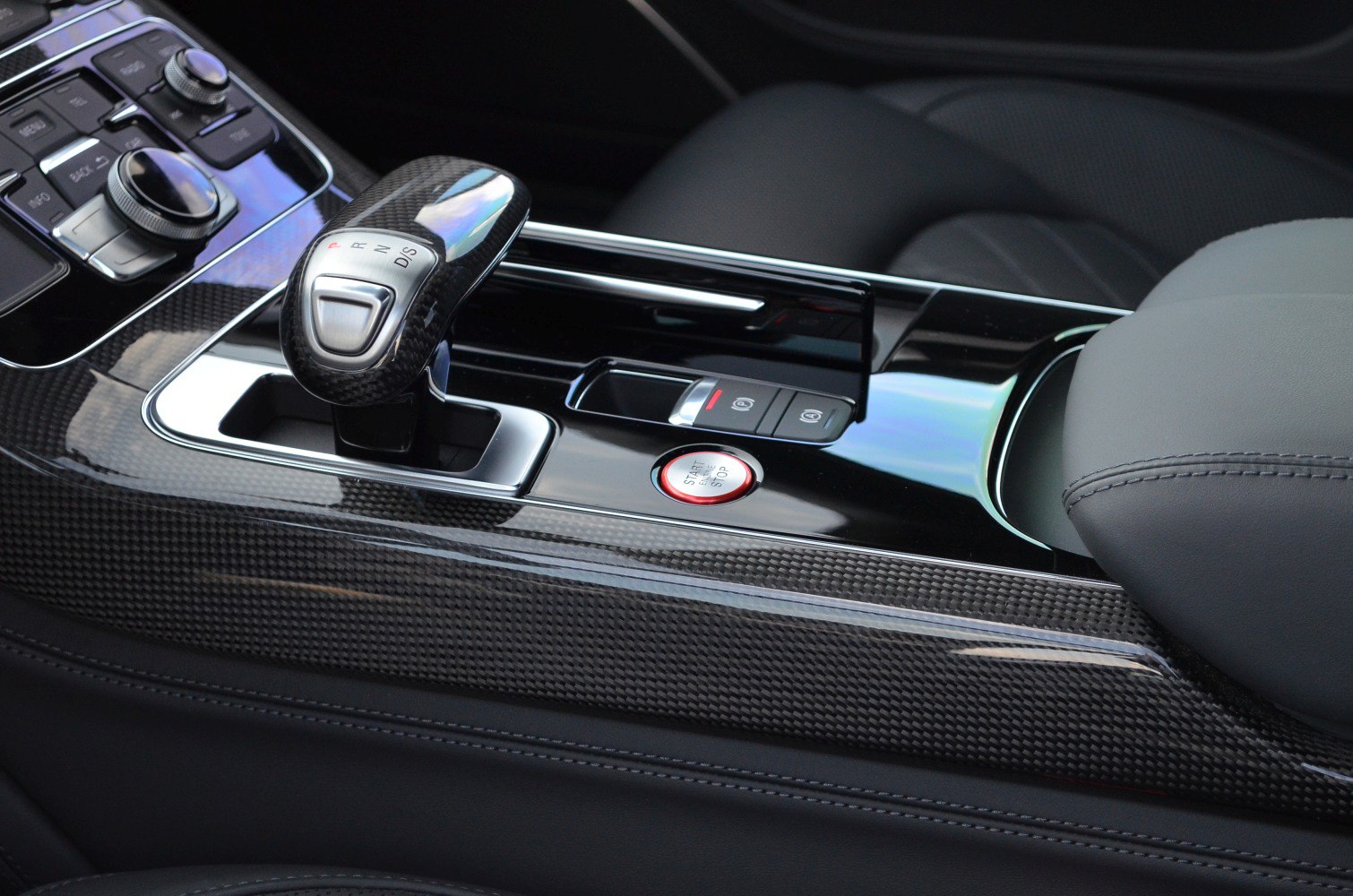 Close-up of gear shifter, carbon fiber trim, and start/stop button