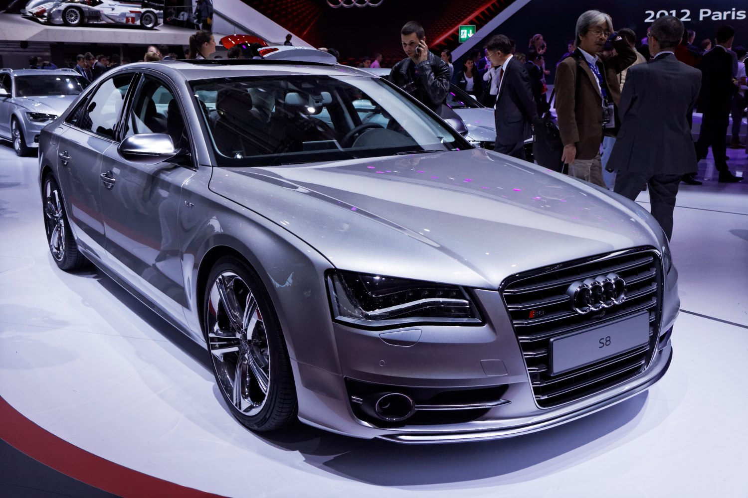 Silver luxury sedan front view with sporty wheels and sleek headlights