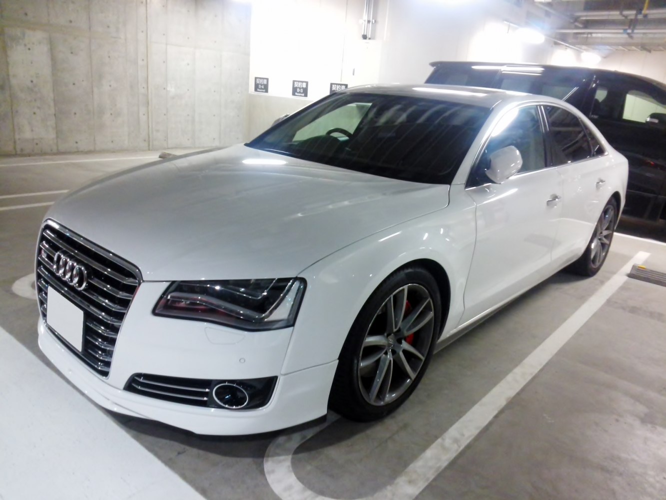 White luxury sedan with signature grille and sporty alloy wheels