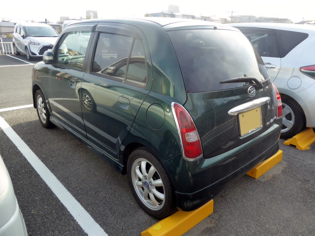 Rear side view of a compact hatchback with vertical taillights
