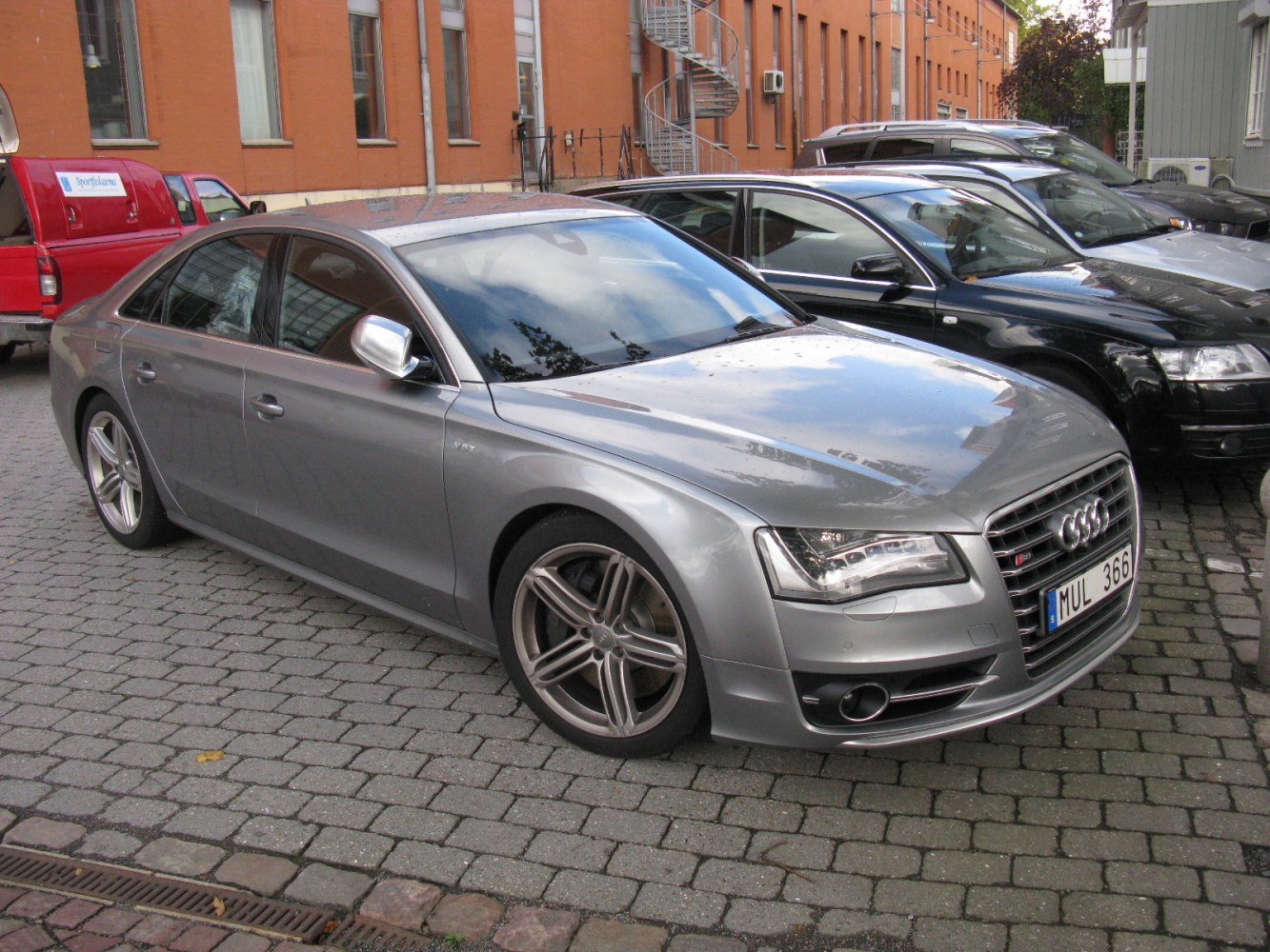 Silver luxury sedan with alloy wheels and front grille