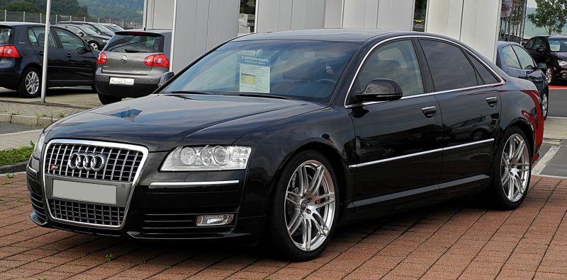 Front view of a black sedan with signature grille and alloy wheels
