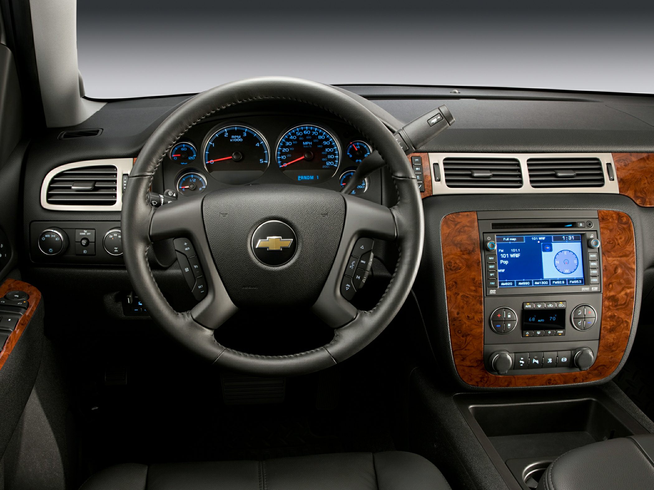Dashboard with steering wheel and infotainment system with wood trim