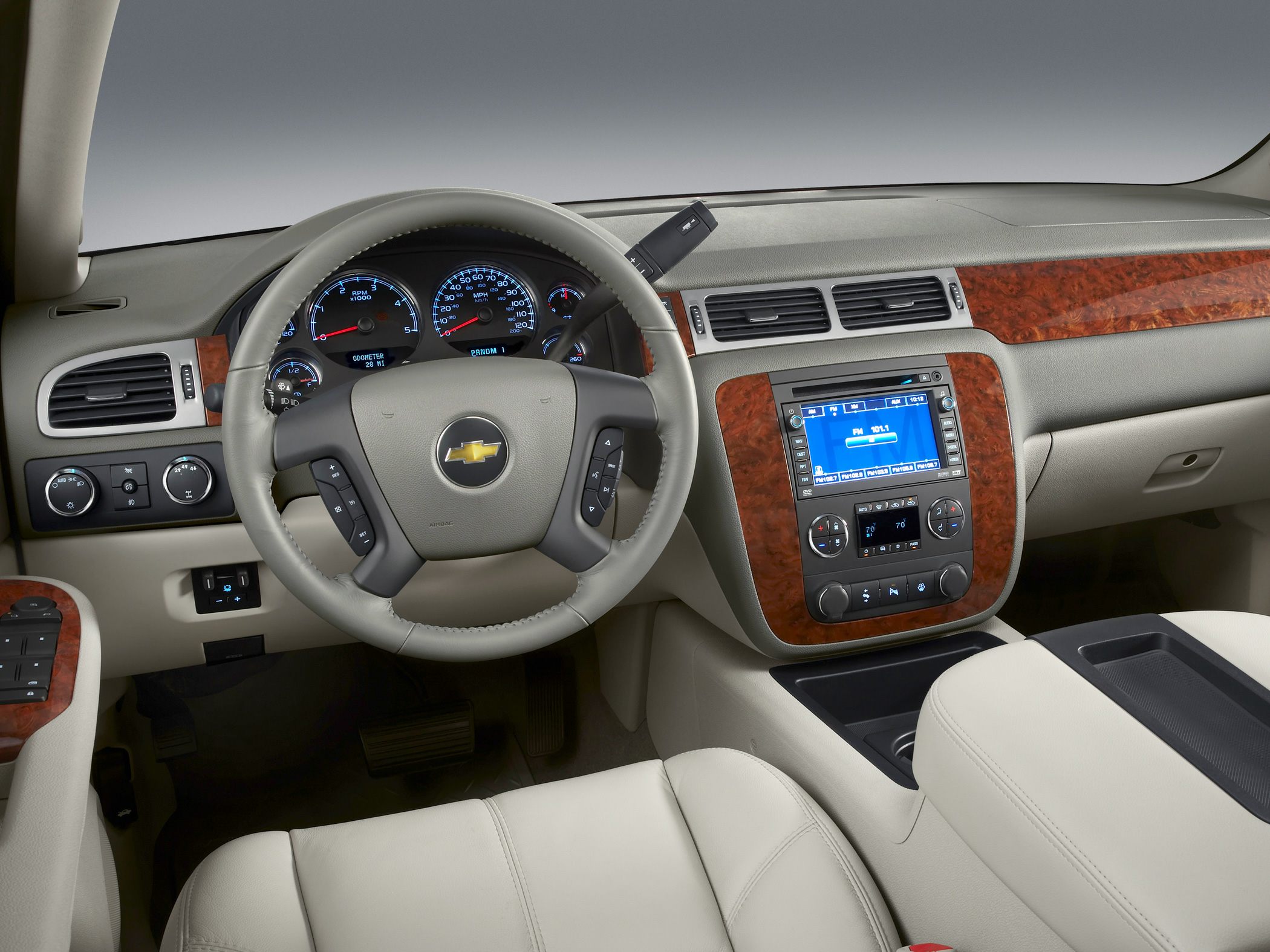 Steering wheel, wood trim dashboard, digital infotainment display