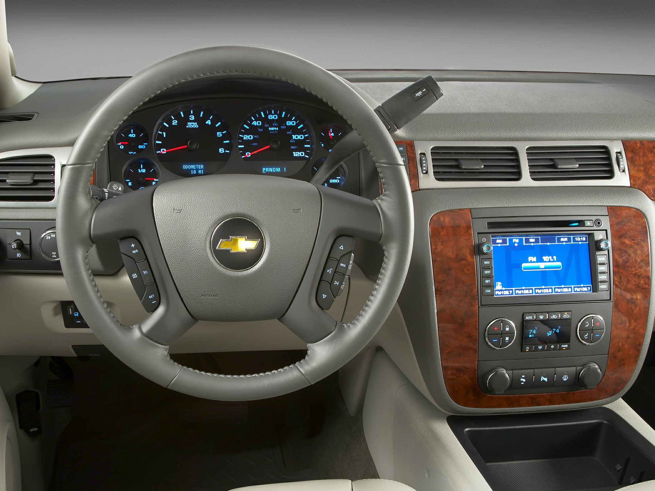 Dashboard and steering wheel with wood grain trim and digital controls