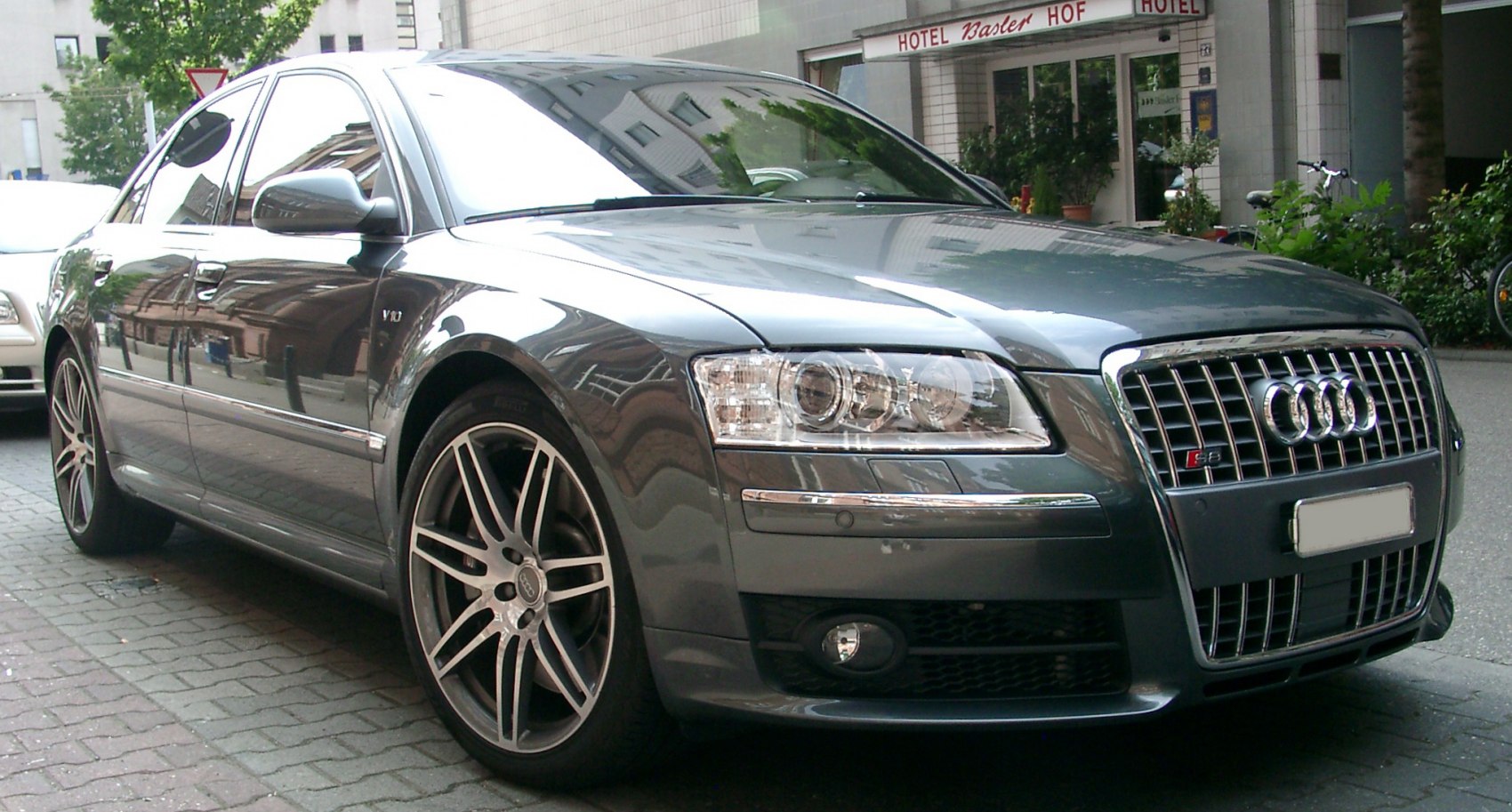 Close-up of front grille, headlights, and alloy wheels.