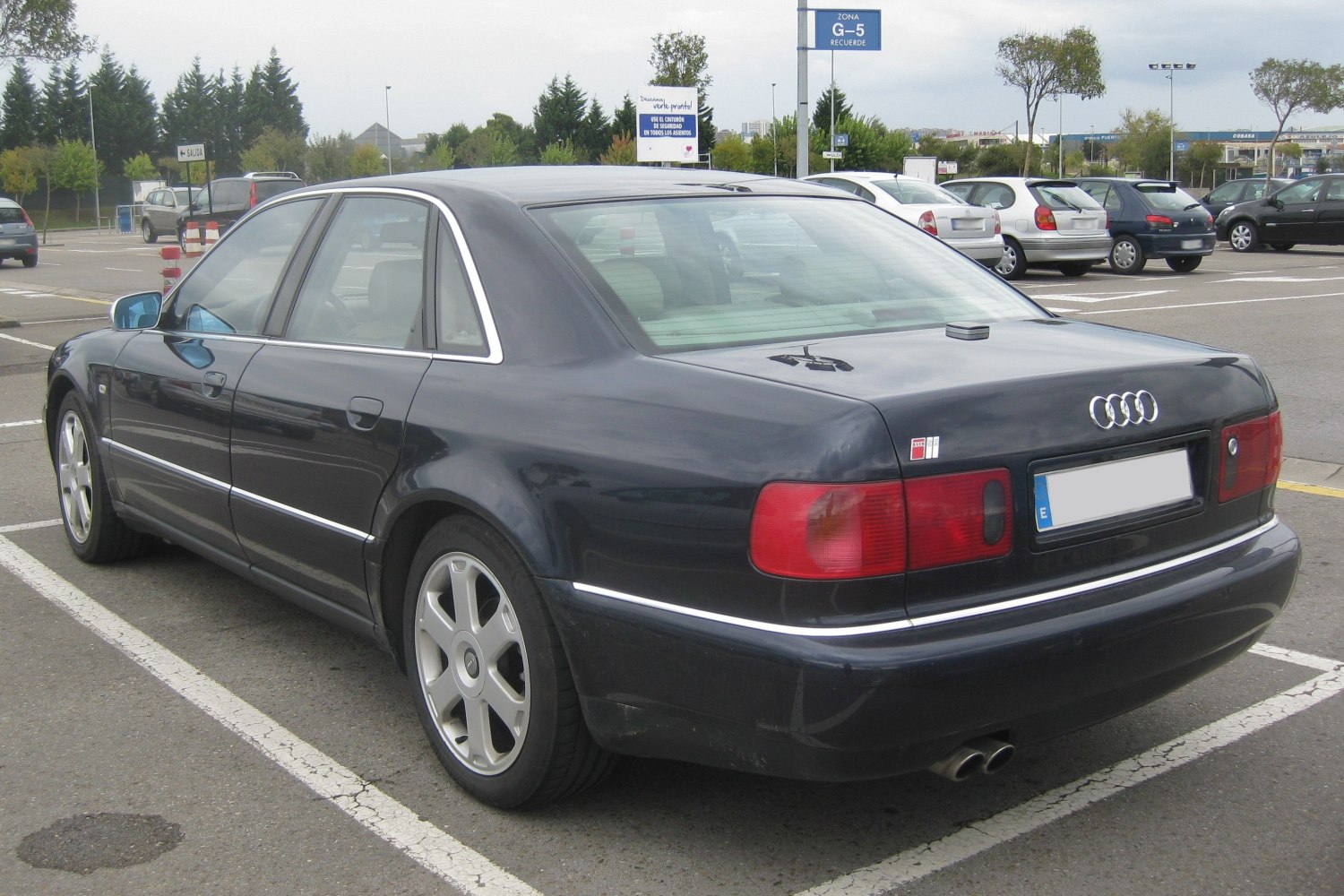 Rear side view of a luxury sedan with distinctive taillights and alloy wheels