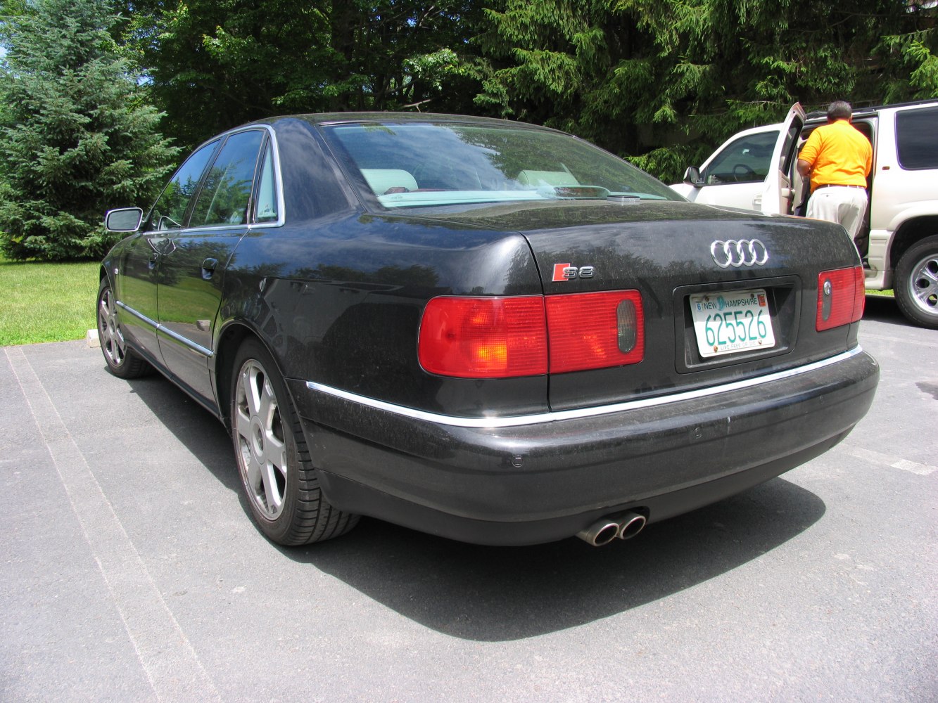 Black Audi sedan rear view with taillights and dual exhaust