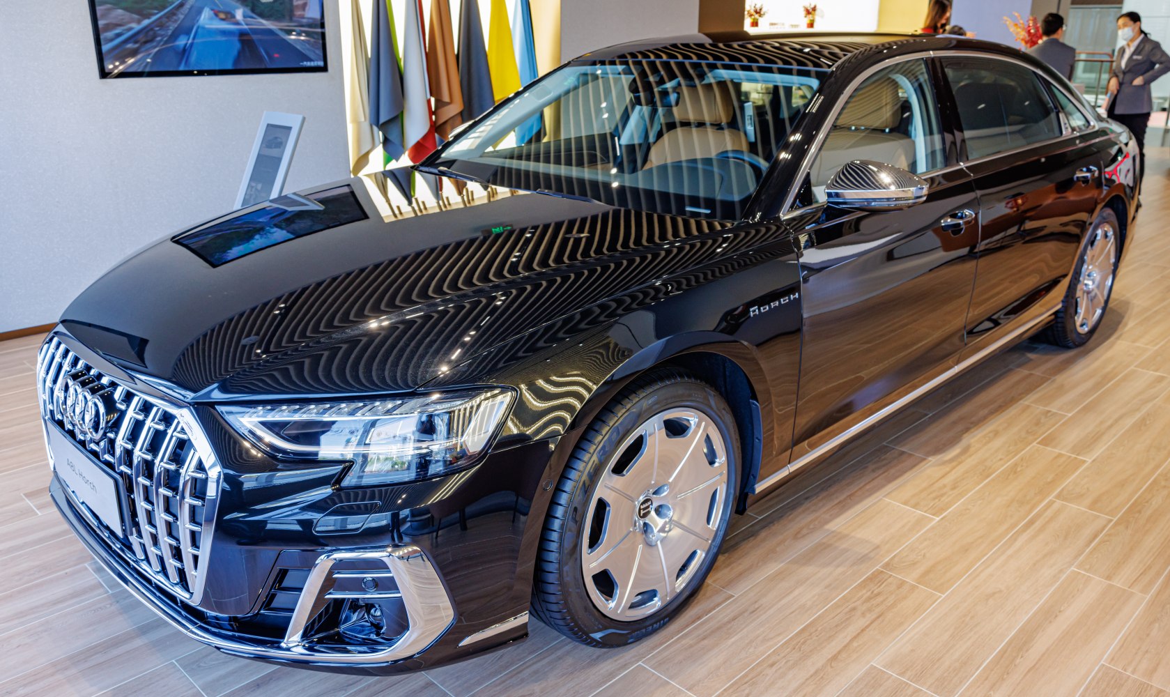 Glossy black luxury sedan with distinct front grille and unique alloy wheels