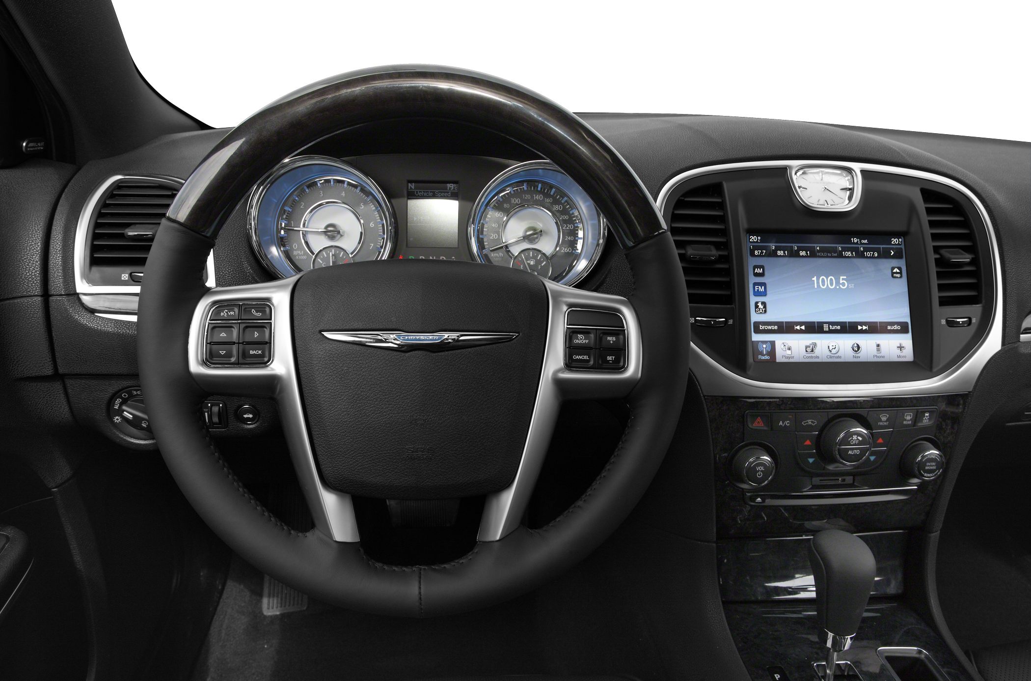 Steering wheel with Chrysler emblem, dual gauge instrument cluster, touchscreen infotainment.