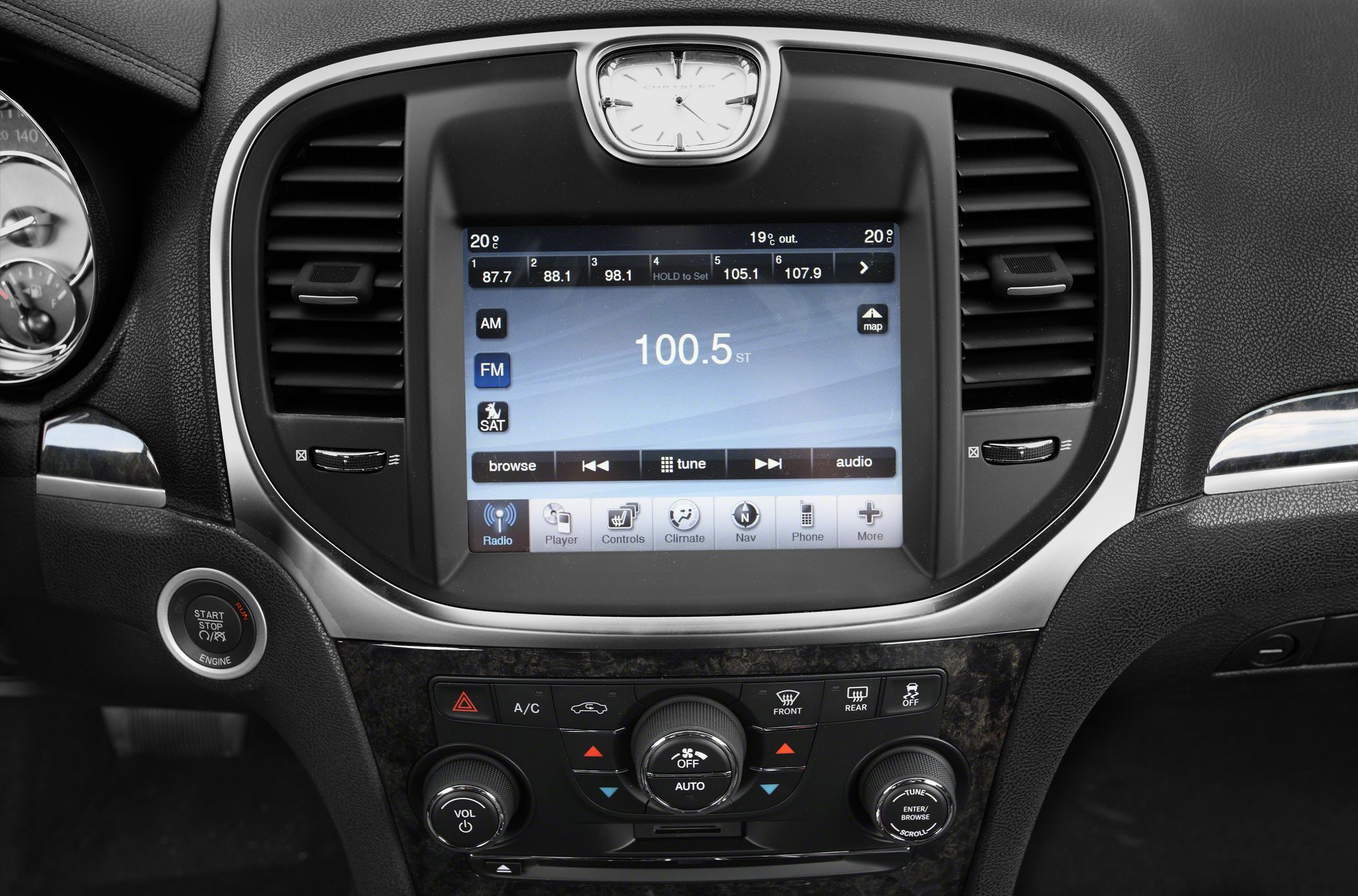Infotainment touchscreen with analog clock and climate control knobs
