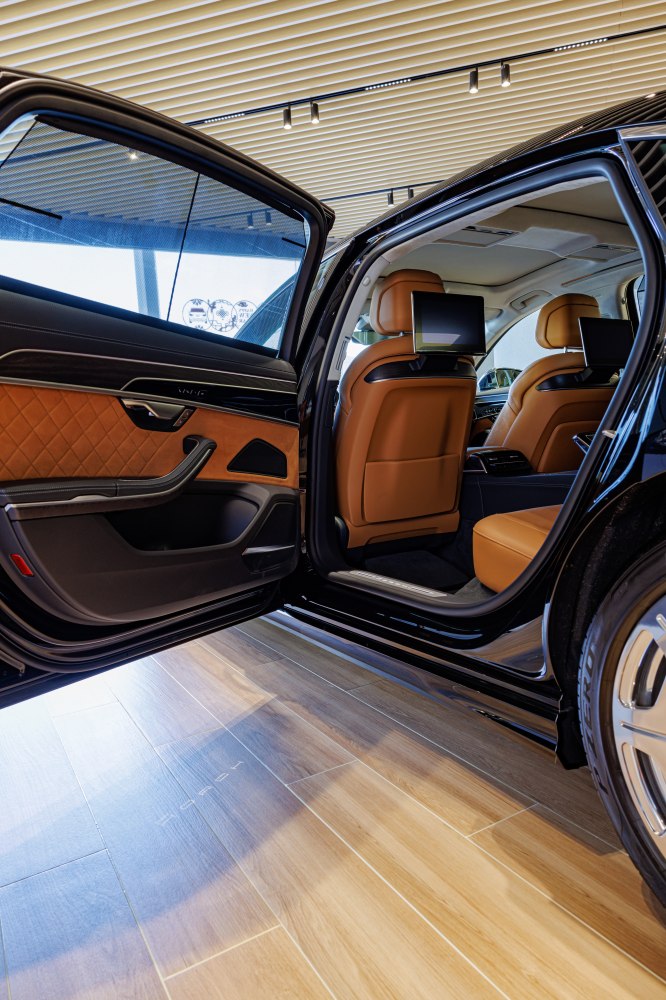 Luxury rear interior with leather seats and digital entertainment screens