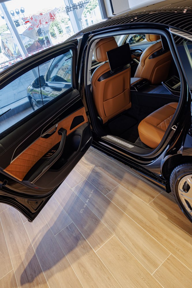 Luxury rear interior with leather seats and rear infotainment.