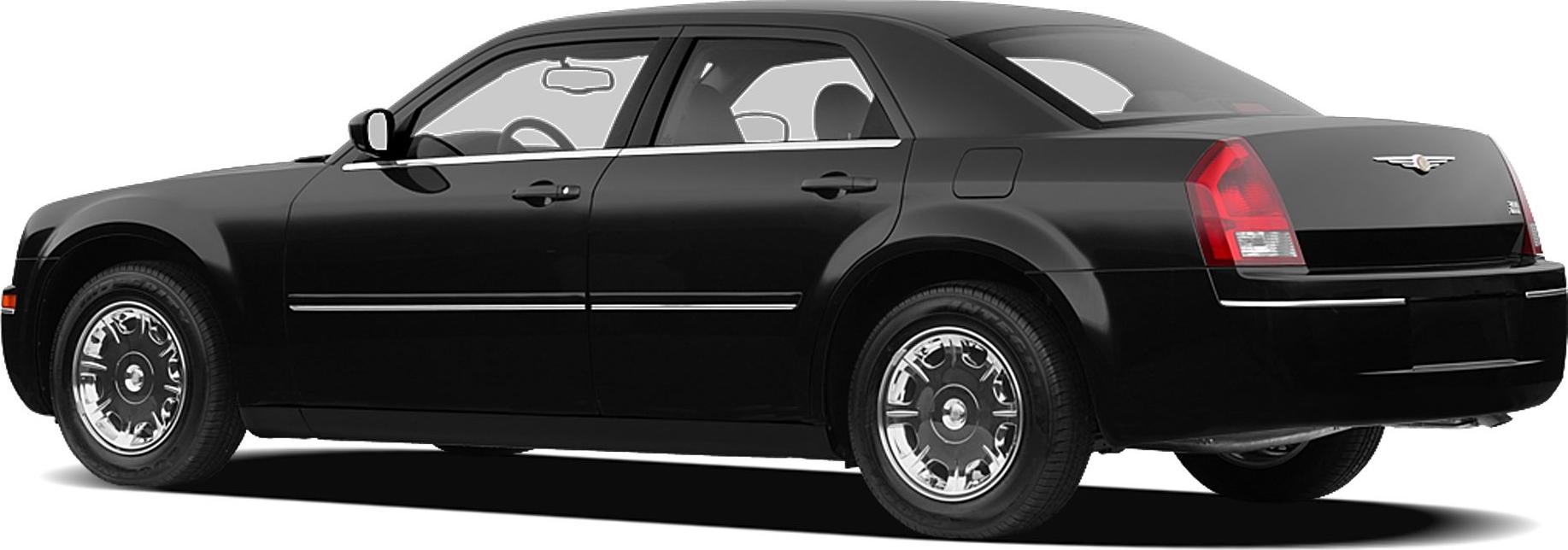 Side profile of a sedan with classic chrome wheels