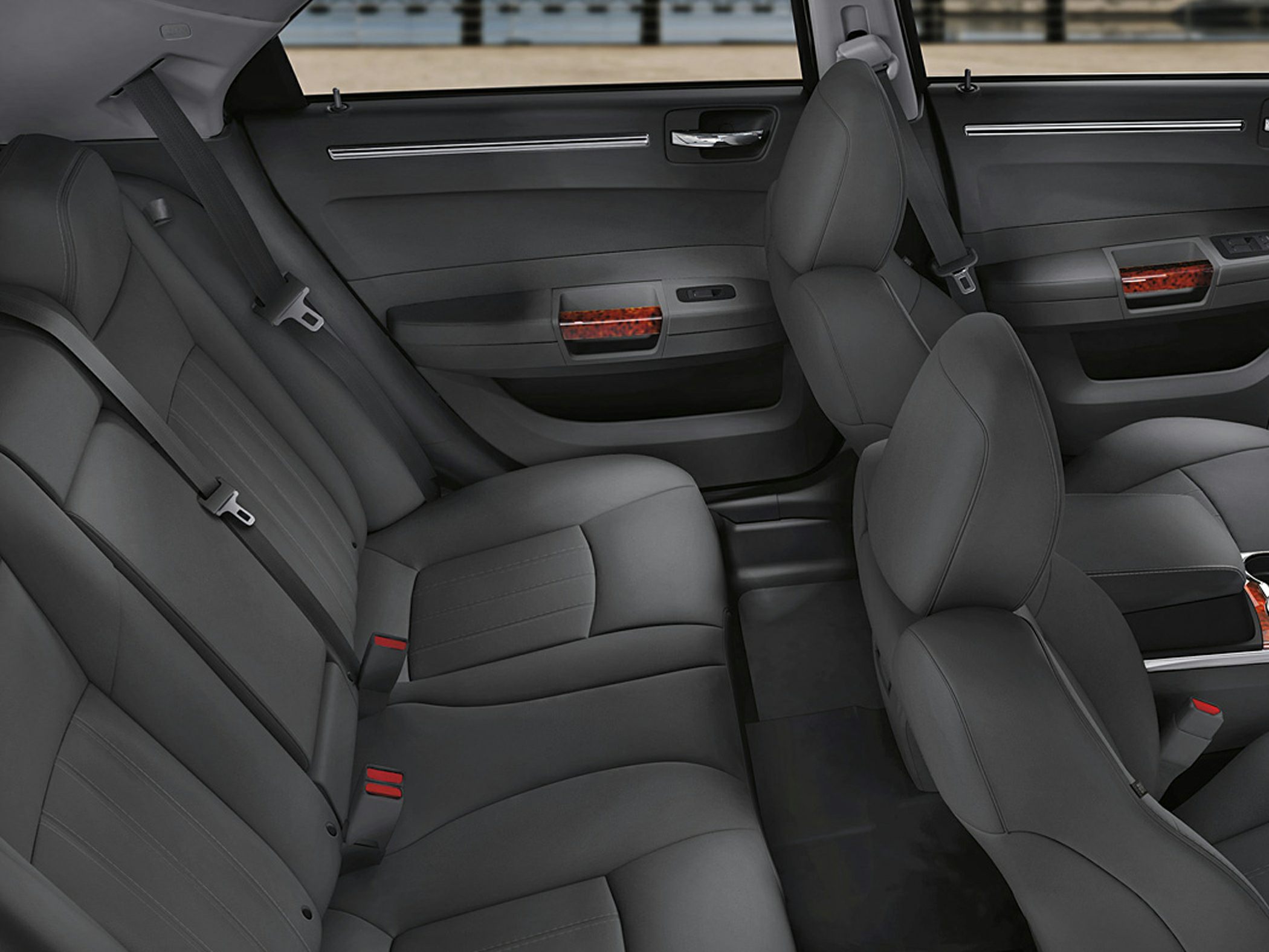 Black leather seats with wood trim accents and seat belts