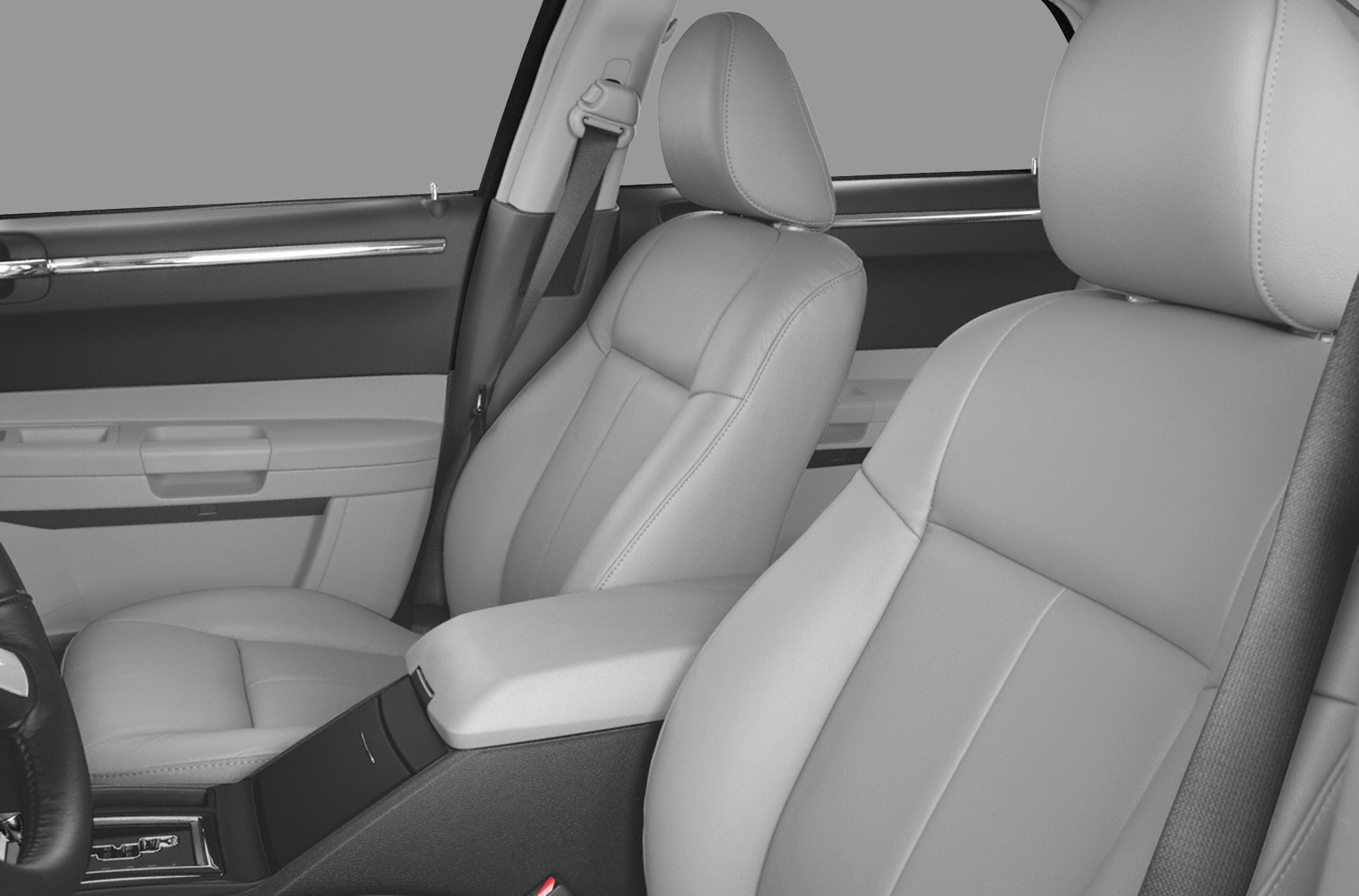 Premium front seats and door panel detail with armrest and seatbelt