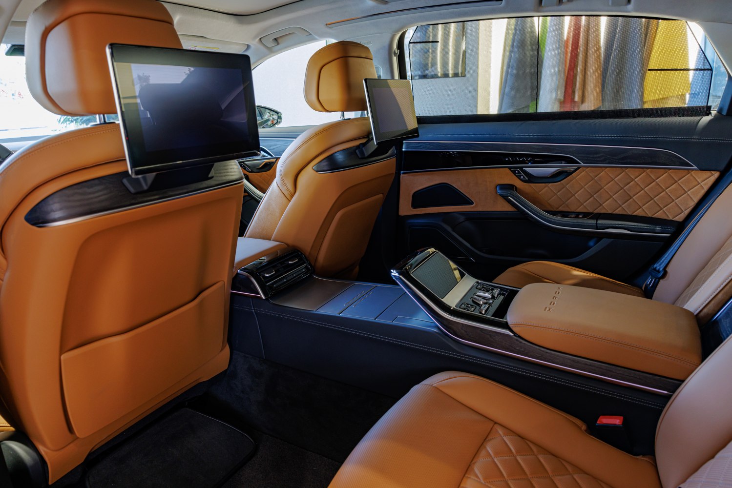 Luxury rear seating with dual entertainment screens and premium leather upholstery