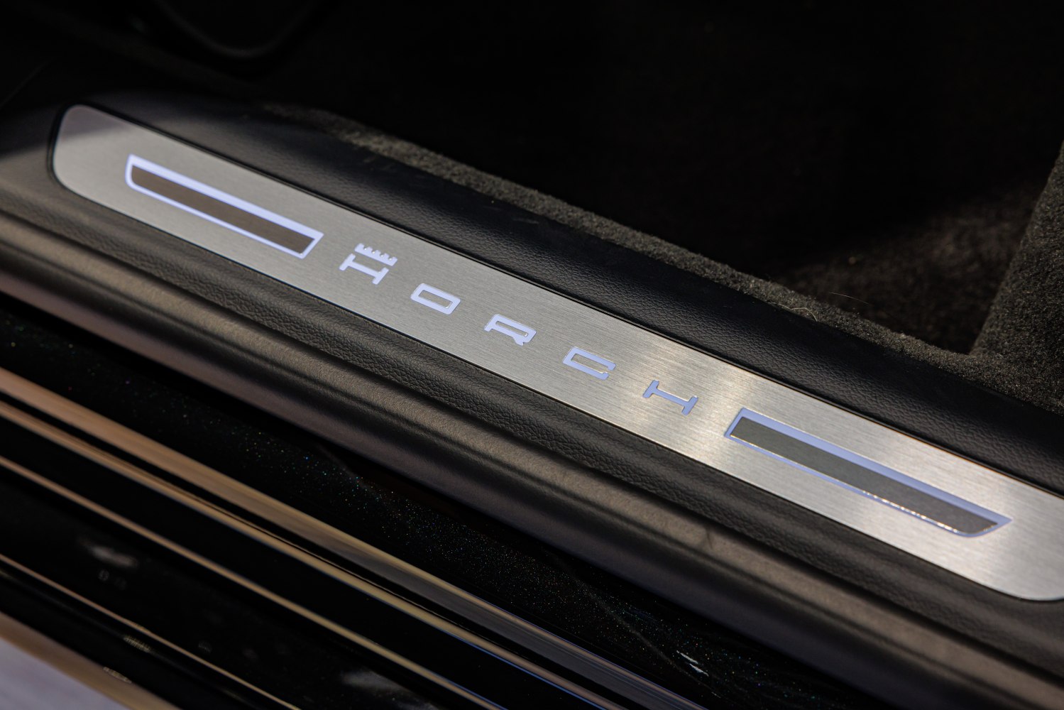 Illuminated Horch door sill plate with brushed metal and lighting