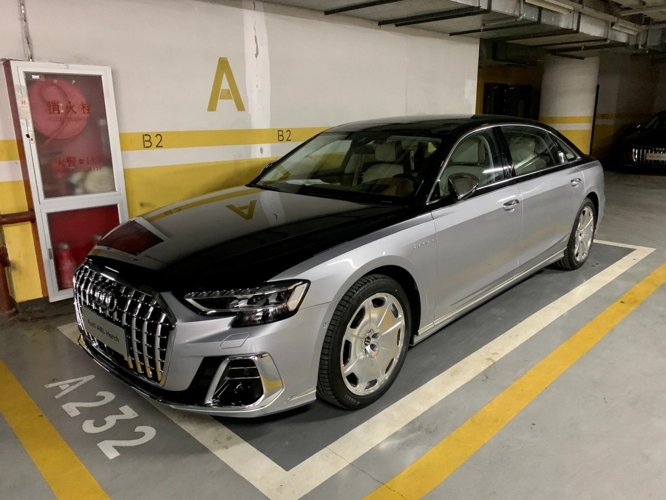 Two-tone luxury sedan with chrome grille and alloy wheels
