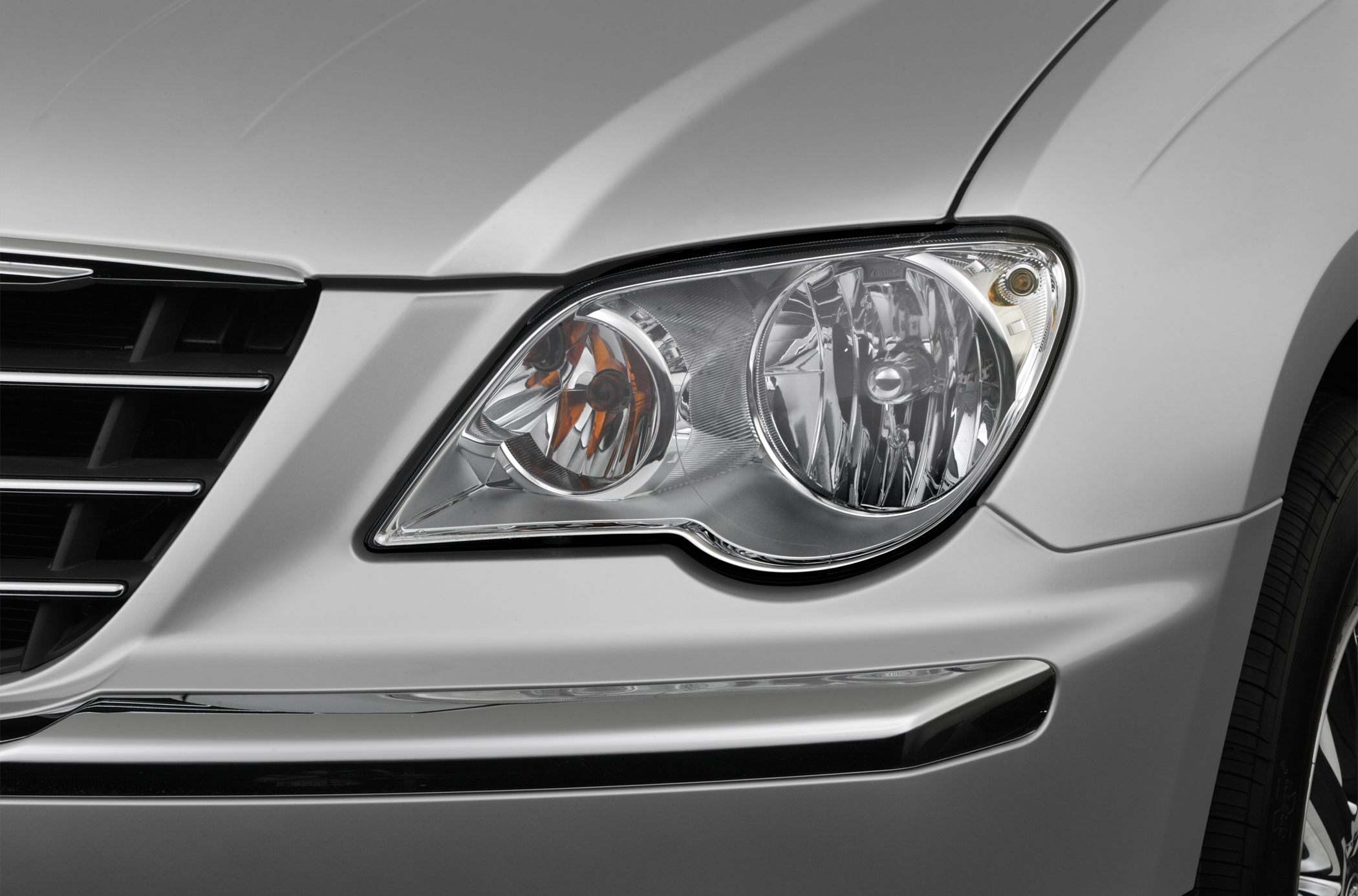 Front headlight and grille close-up with chrome detailing