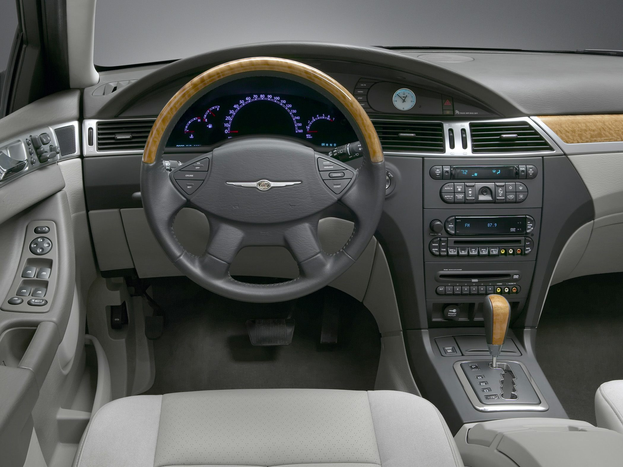 Wood-trimmed steering wheel and integrated dashboard controls