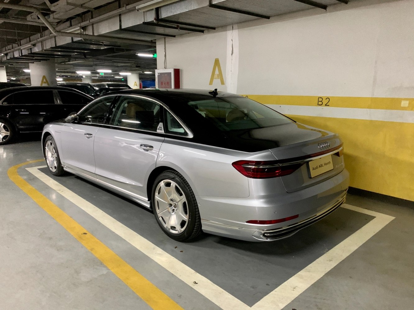 Luxury sedan rear and side exterior with two-tone paint and alloy wheels.