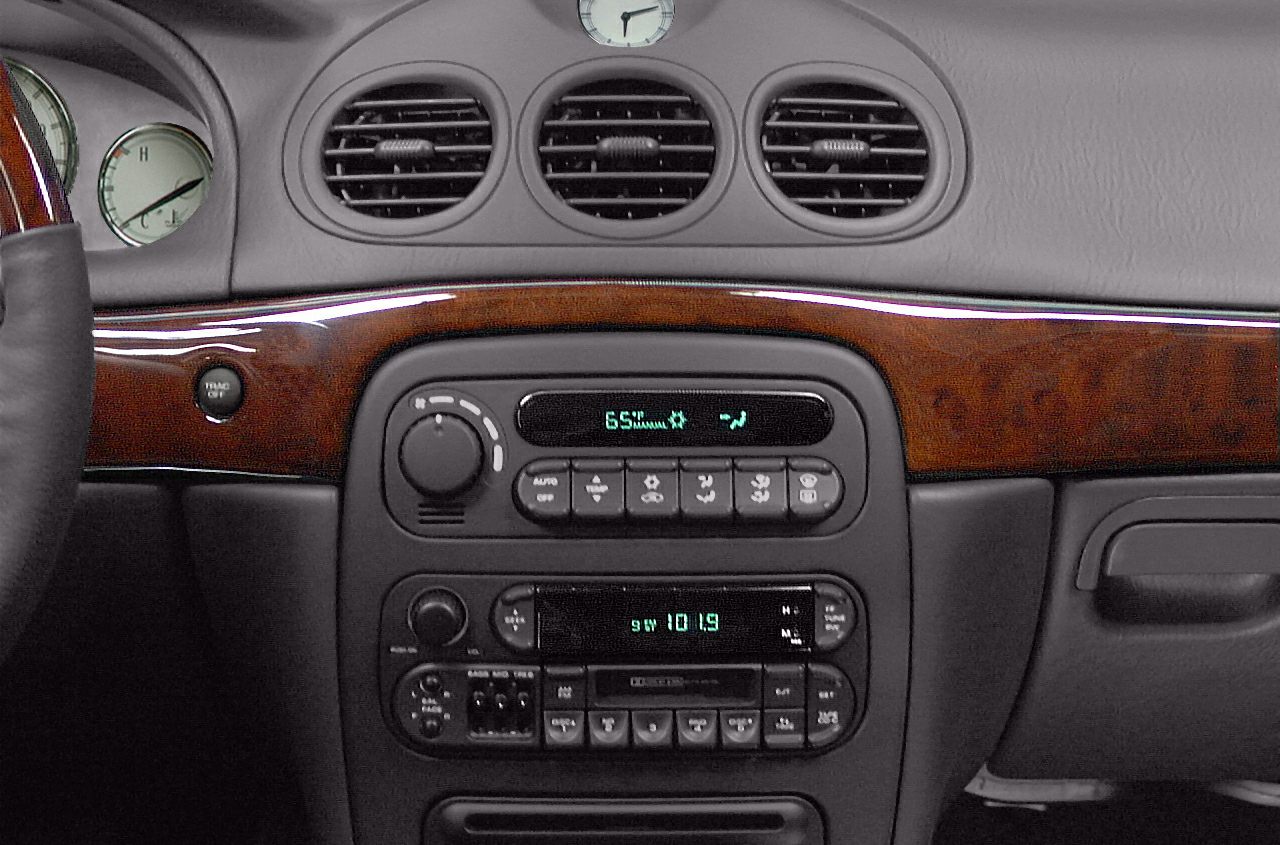 Dashboard with analog climate controls, wood trim, and classic radio unit