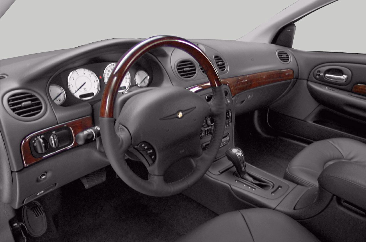Wood-trimmed steering wheel and elegant dashboard with automatic gear shifter