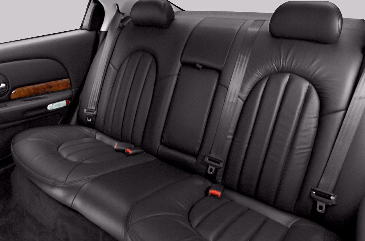 Black leather rear seats with stitching and seat belts