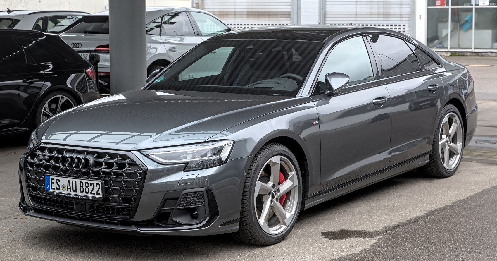 Luxury sedan front view with aggressive grille and sporty alloy wheels
