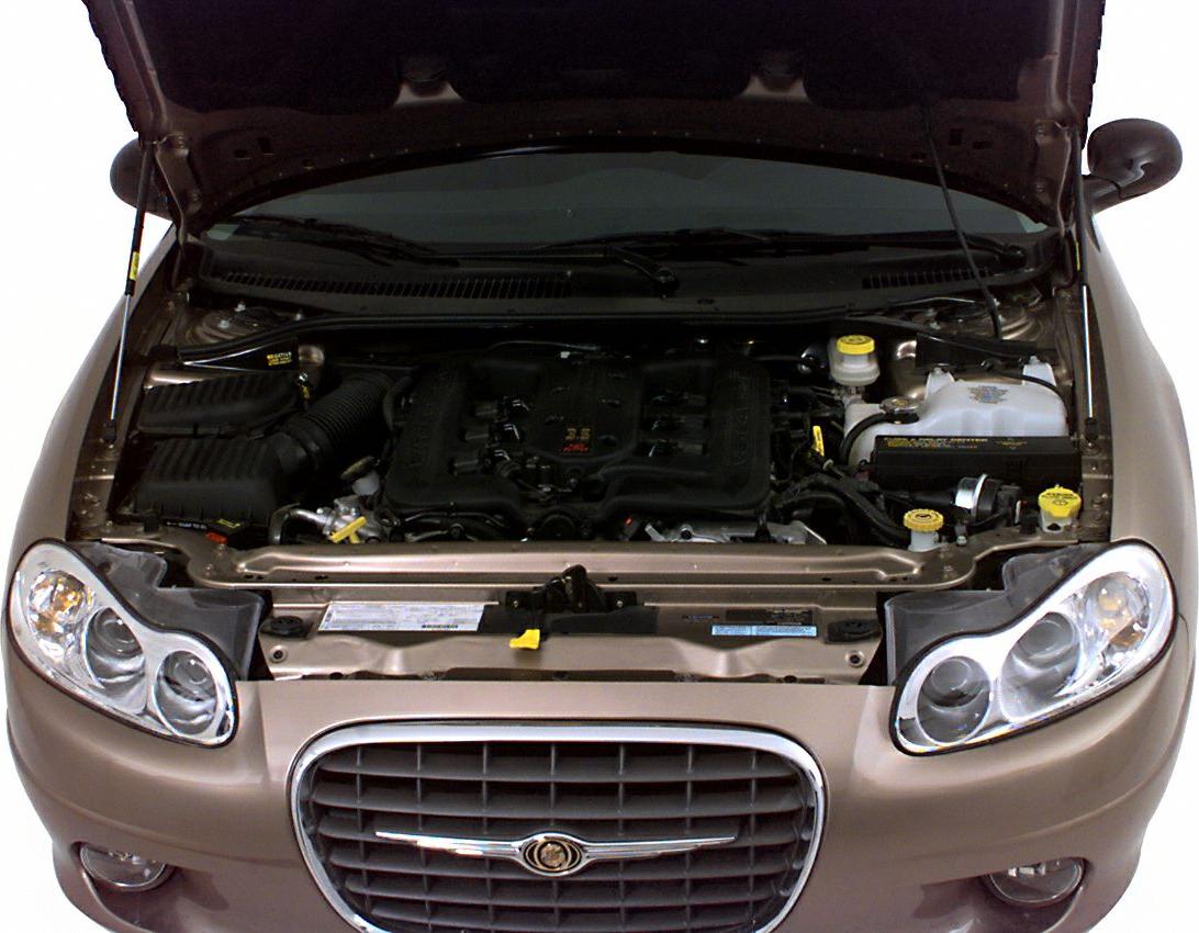 Engine bay with 3.5L V6, open hood, front grille, dual round headlights