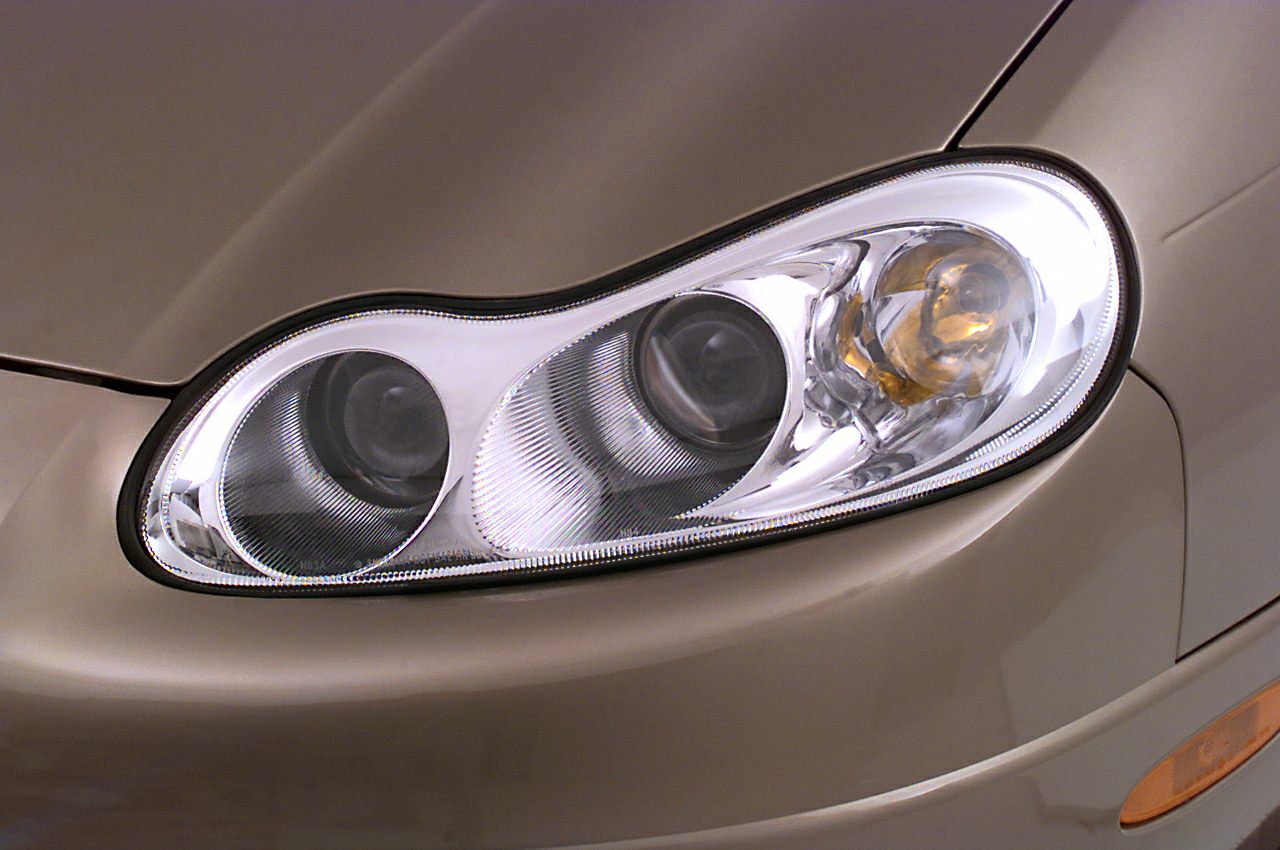 Close-up of multi-lens headlight with reflector and bulb details.
