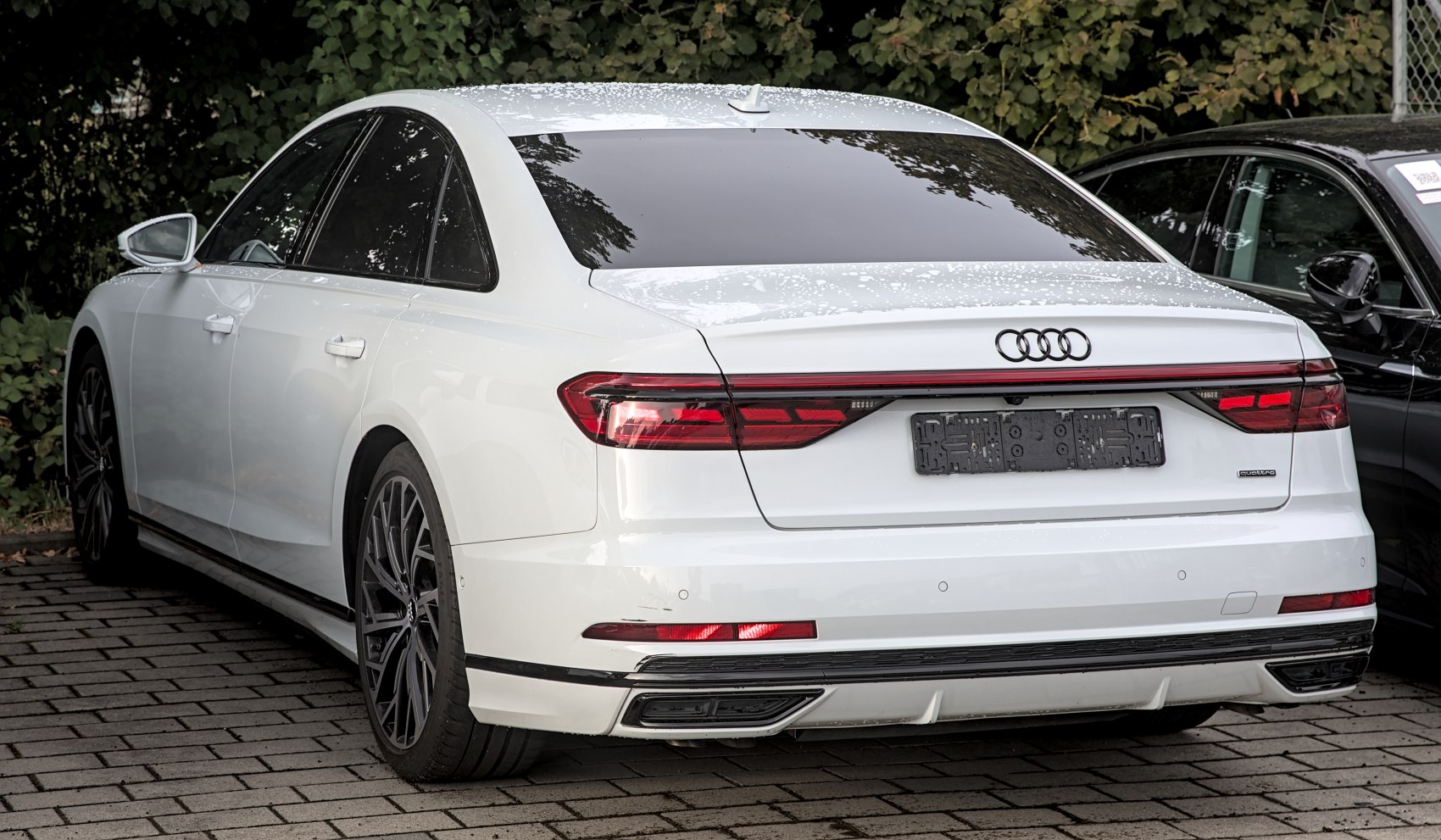 LED rear taillights and dual integrated exhausts on luxury sedan rear