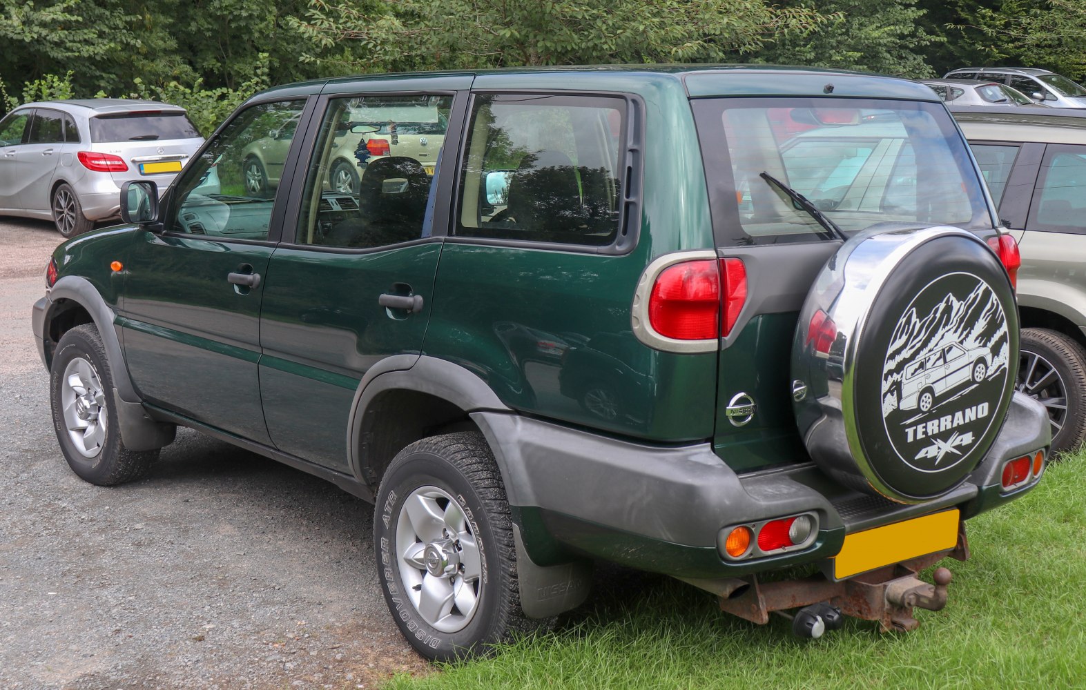 Off-road SUV rear side with spare tire cover and rugged design