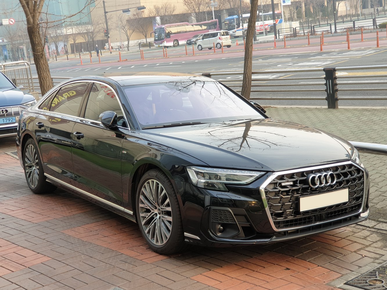 Luxury sedan with aggressive front grille and sharp LED headlights