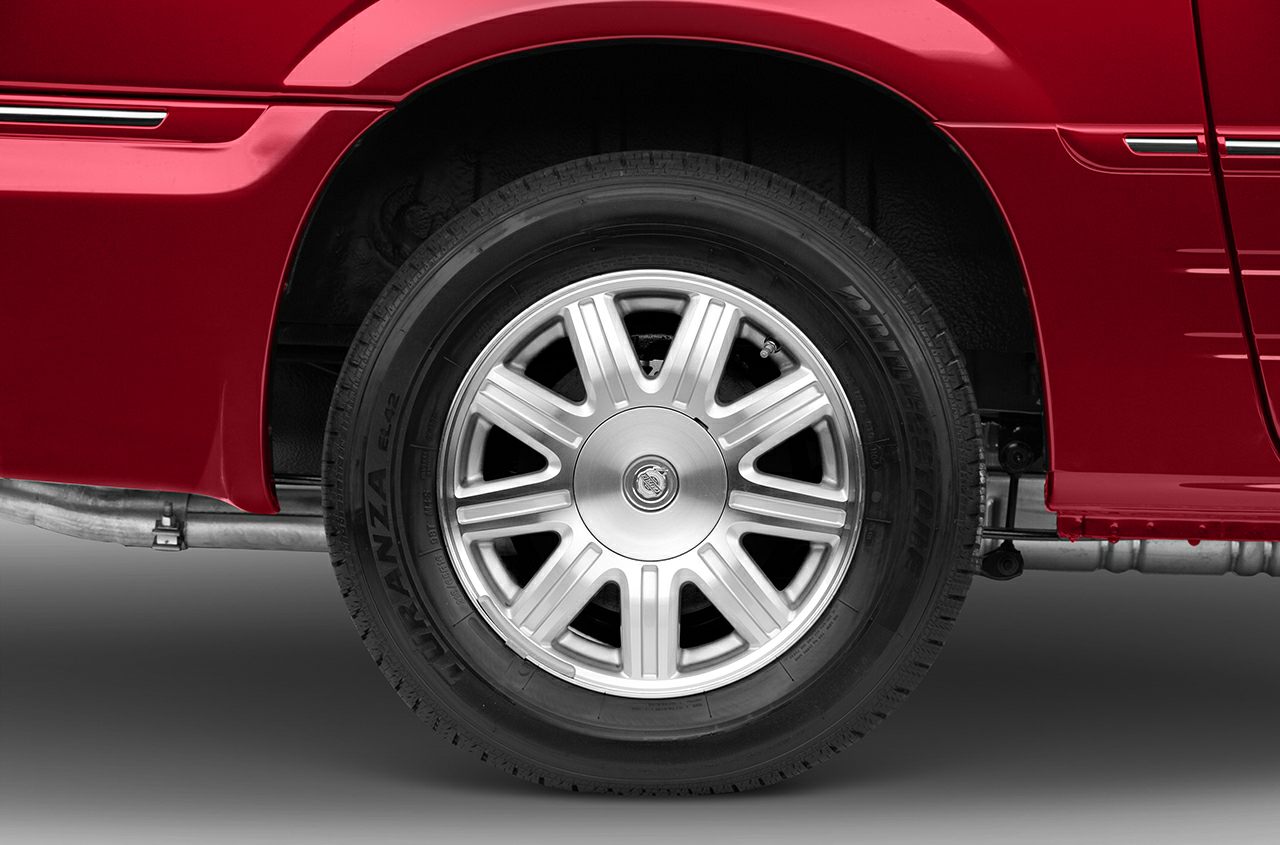 Alloy wheel and tire close-up with Bridgestone branding and detailed rim design.