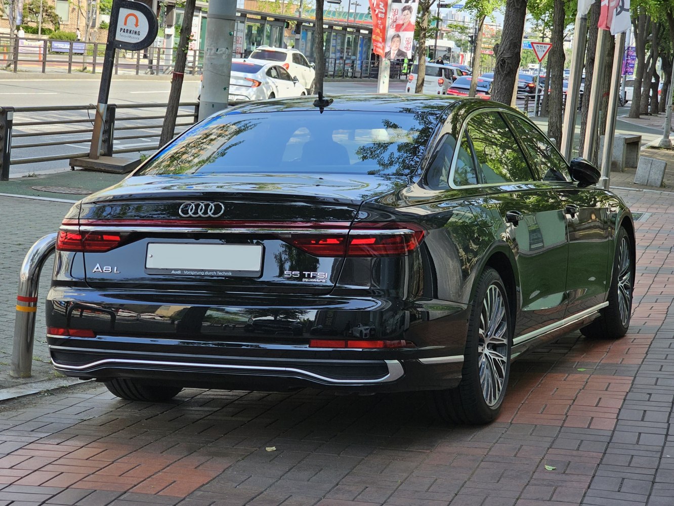 Luxury sedan rear with LED tail lights and alloy wheels