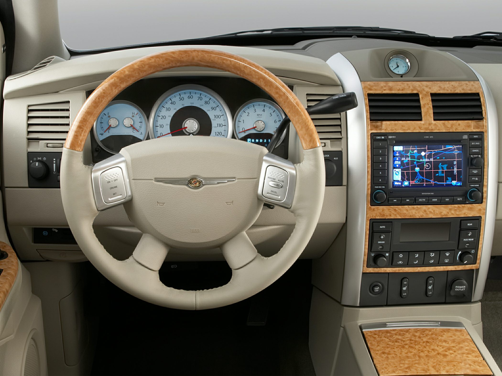 Wood-trimmed steering wheel and navigation system on dashboard