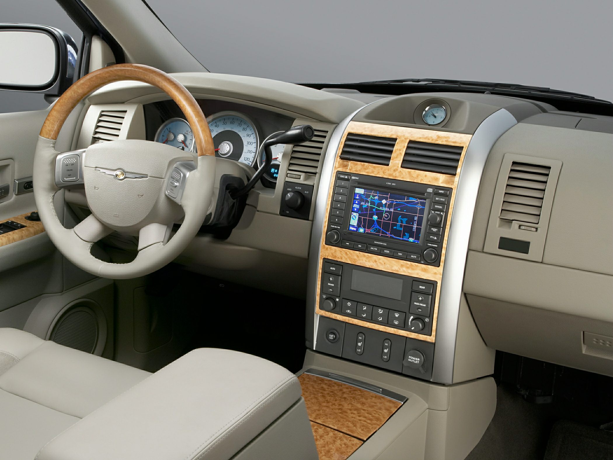 Beige interior with wood trim, navigation screen, and multifunction steering wheel