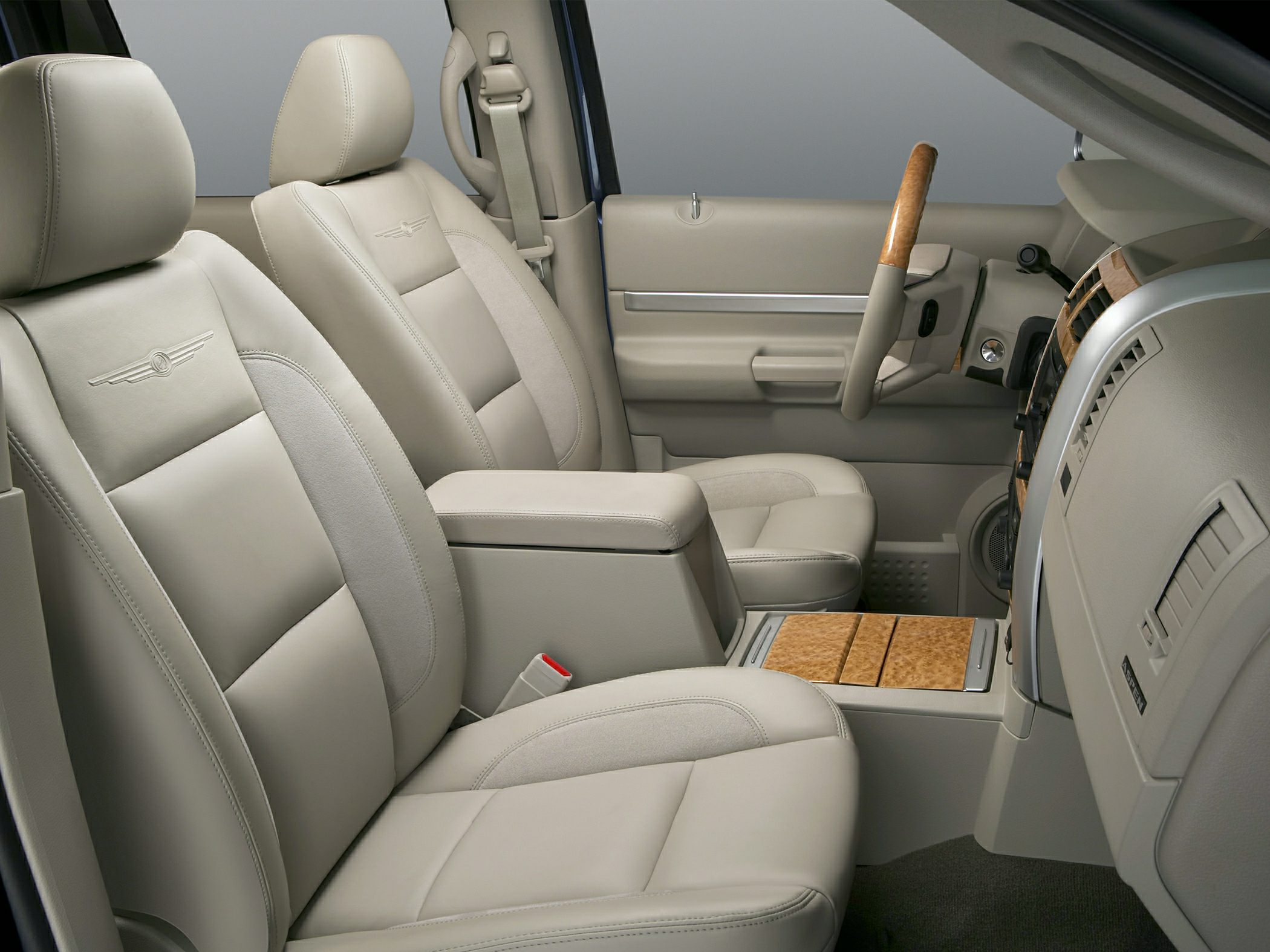 Beige leather seats and wood trim accents in car interior