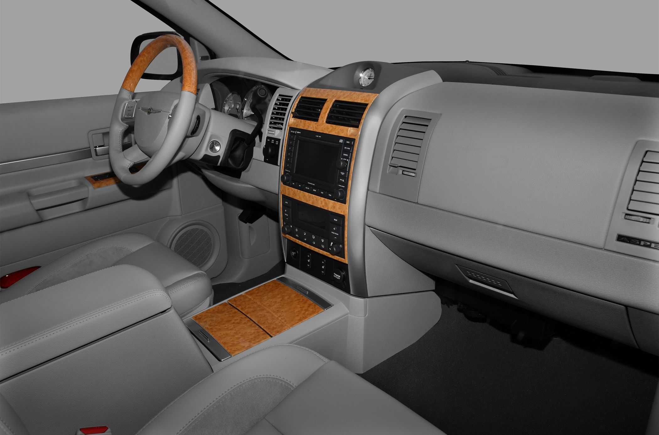 Luxury interior with wood trim, steering wheel, and dashboard controls