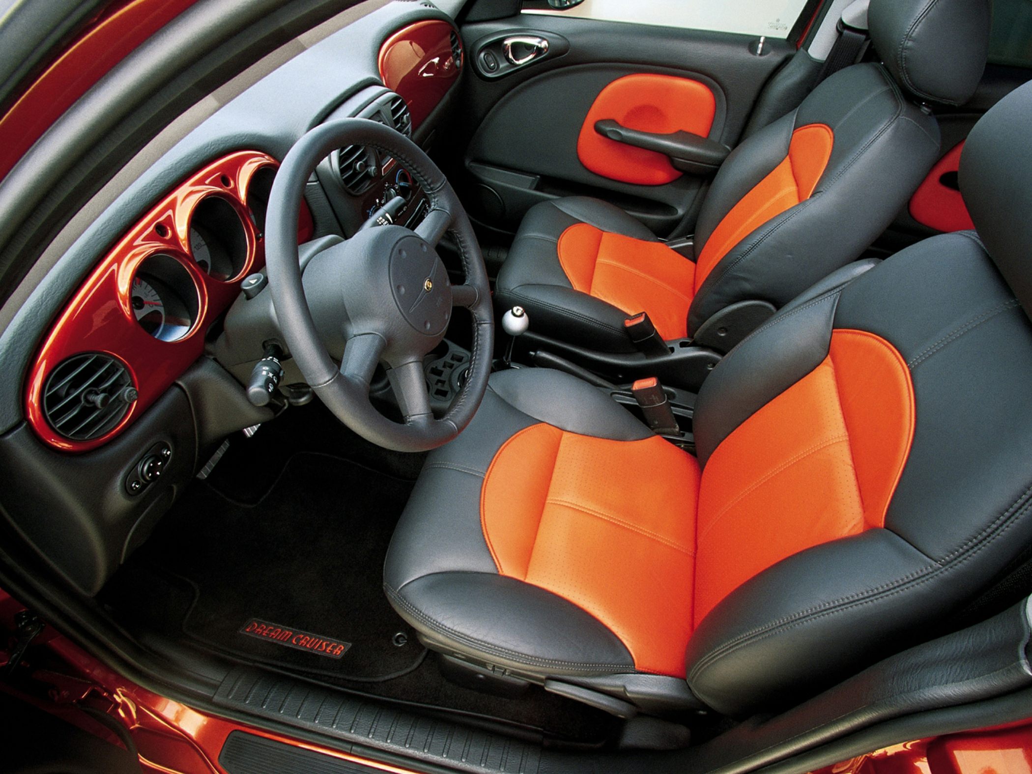 Two-tone orange and black seats with matching dashboard interior