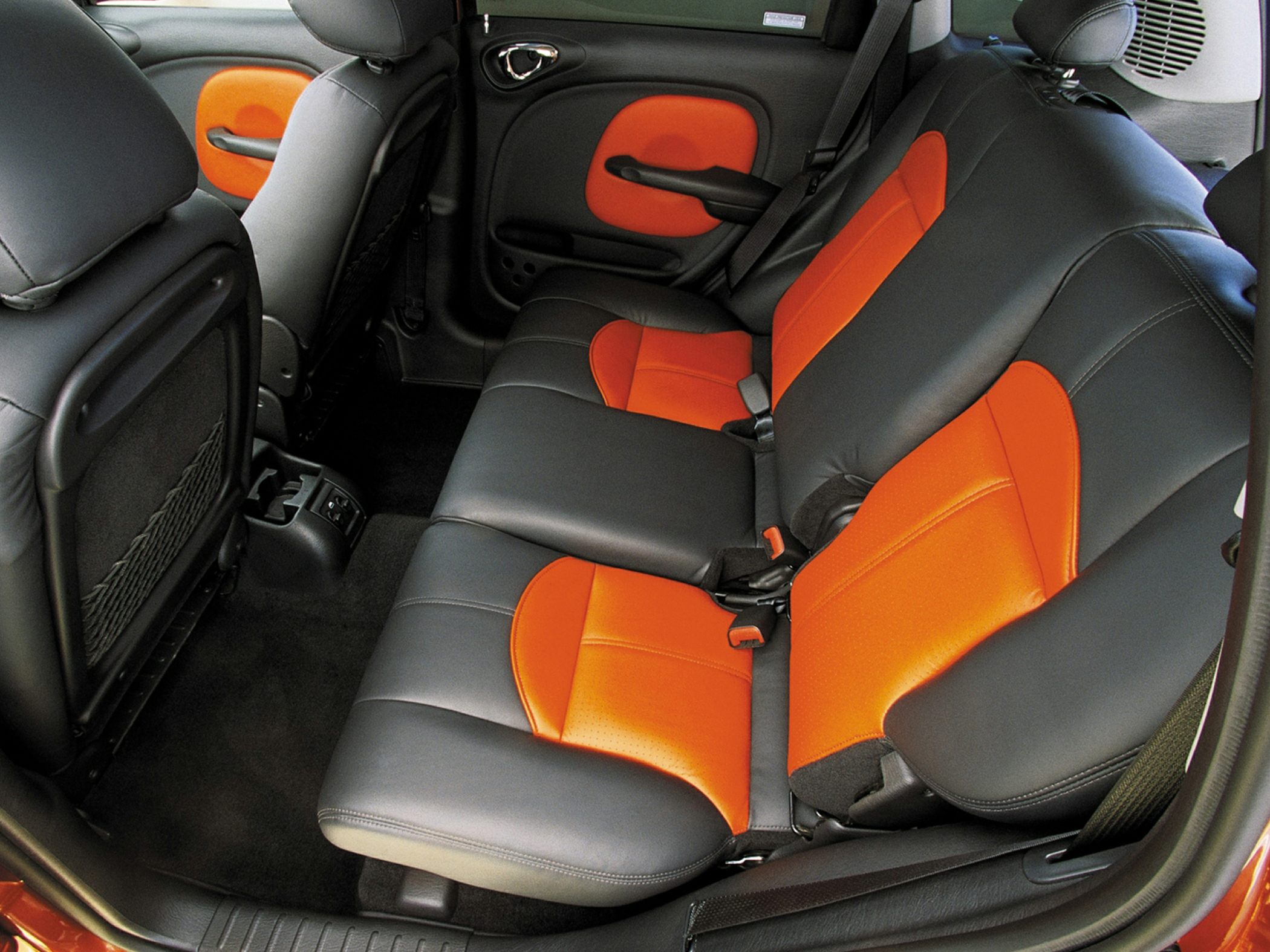 Rear seat interior with black and orange upholstery and door panels