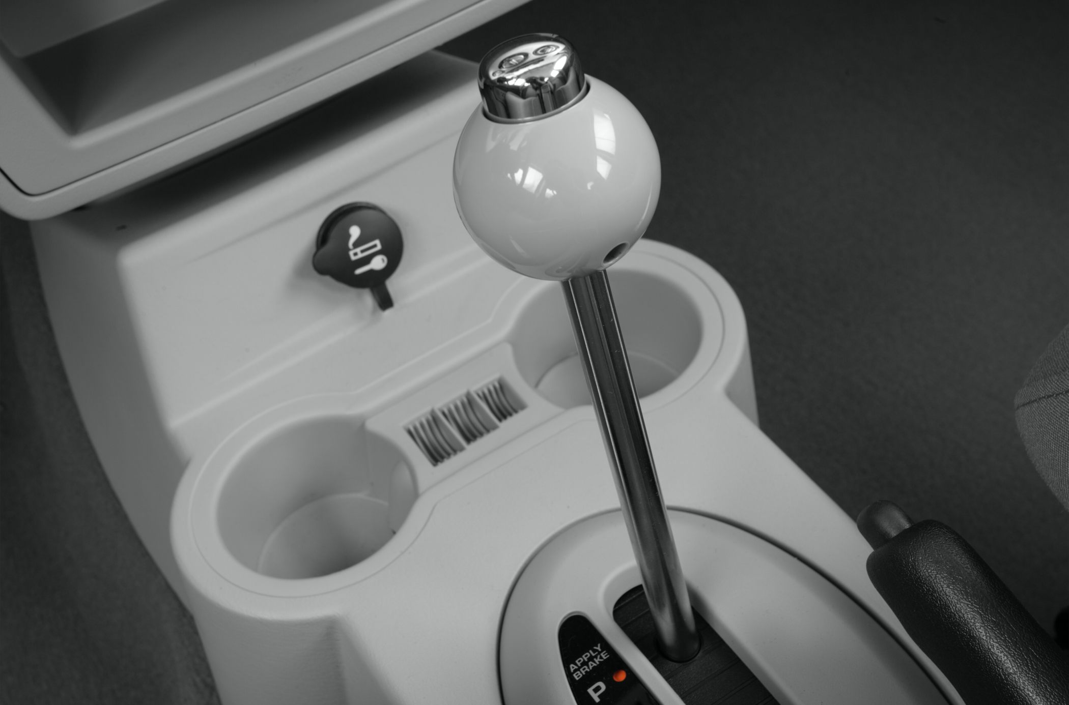 Gear shift lever and center console with cup holders and parking brake lever